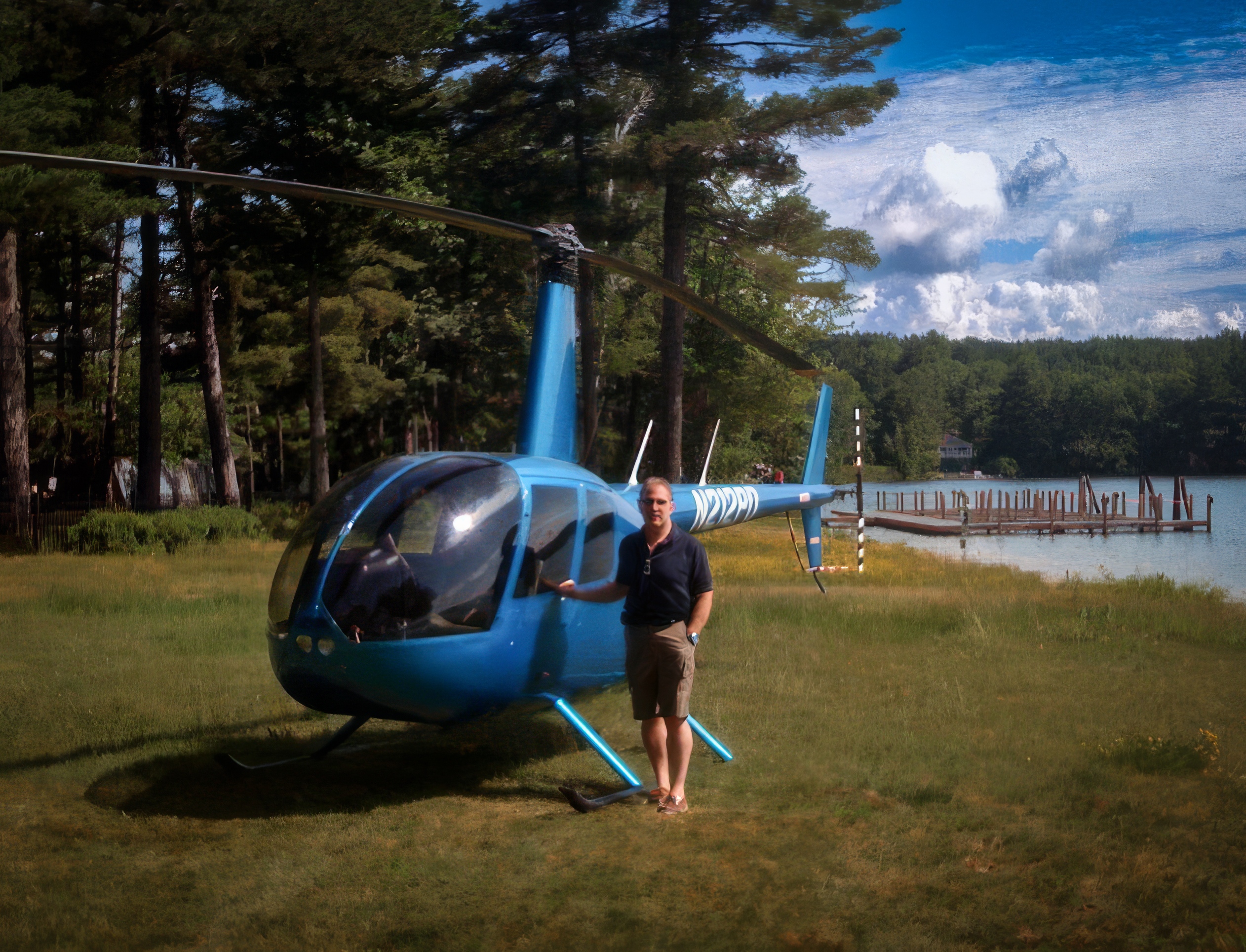 Dave Altobelli standing in front of his Robinson R44 Helicopter